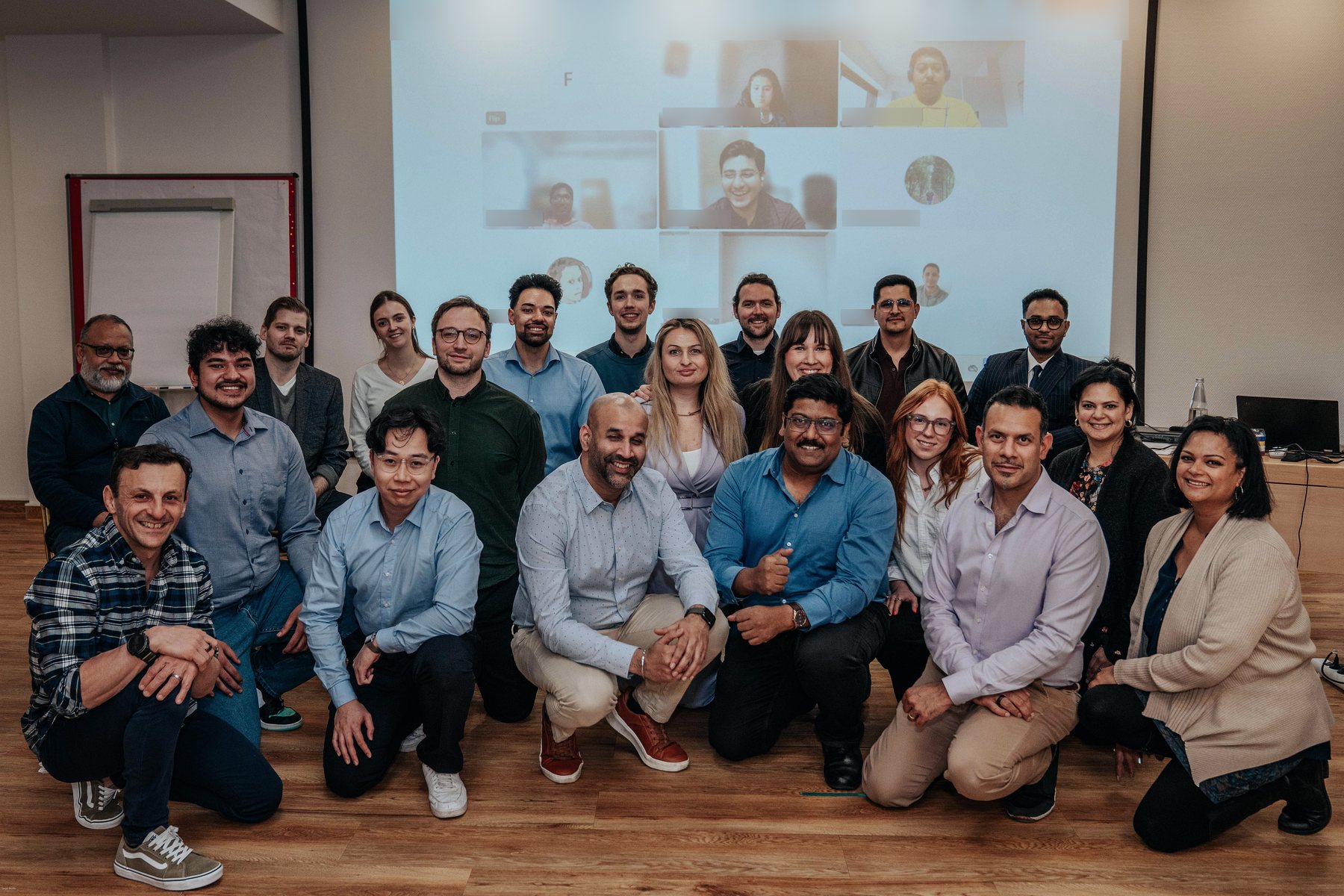 The Bosenet team together in a meeting room, with colleagues joining on screen